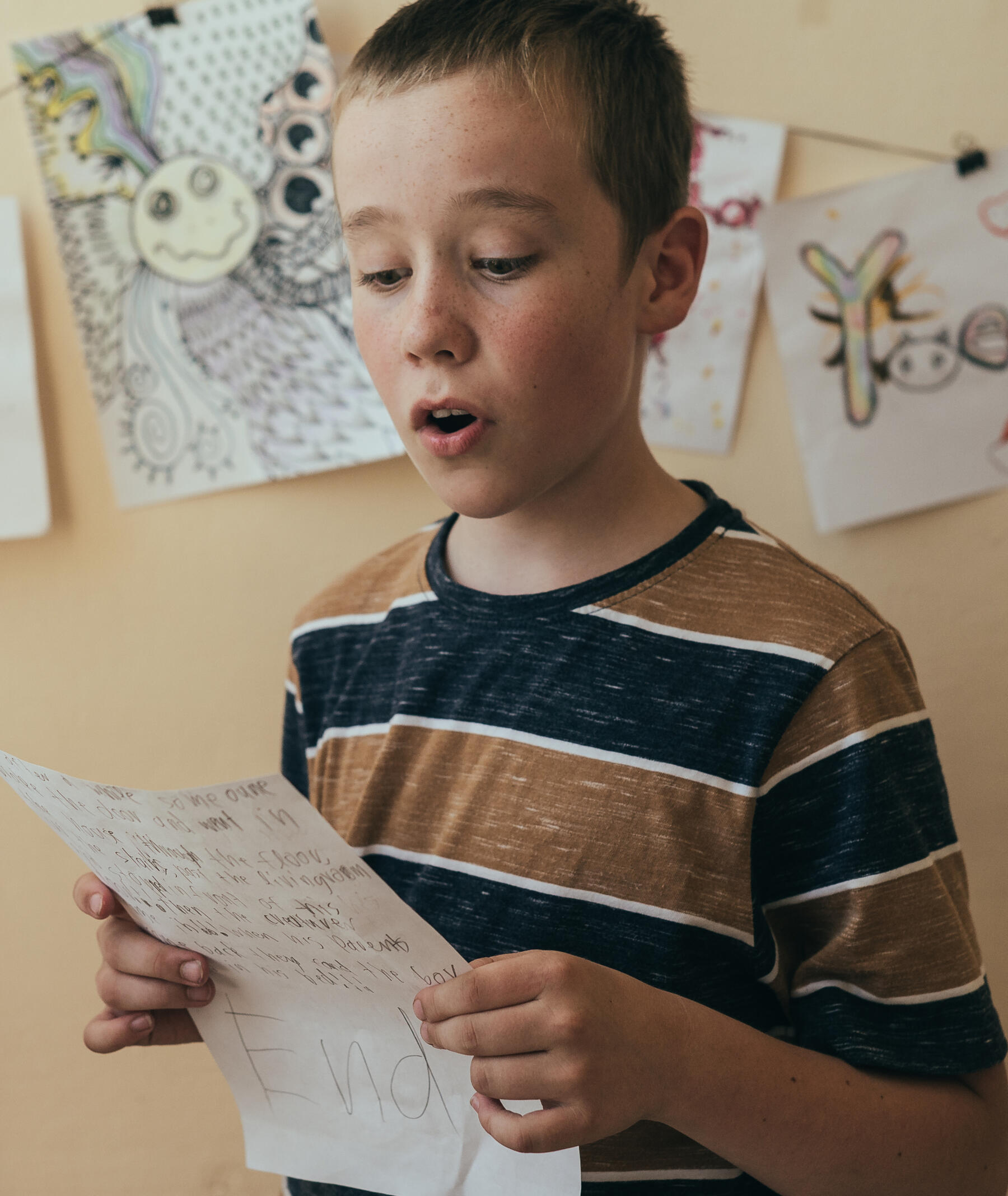 young student reading original work for the audience