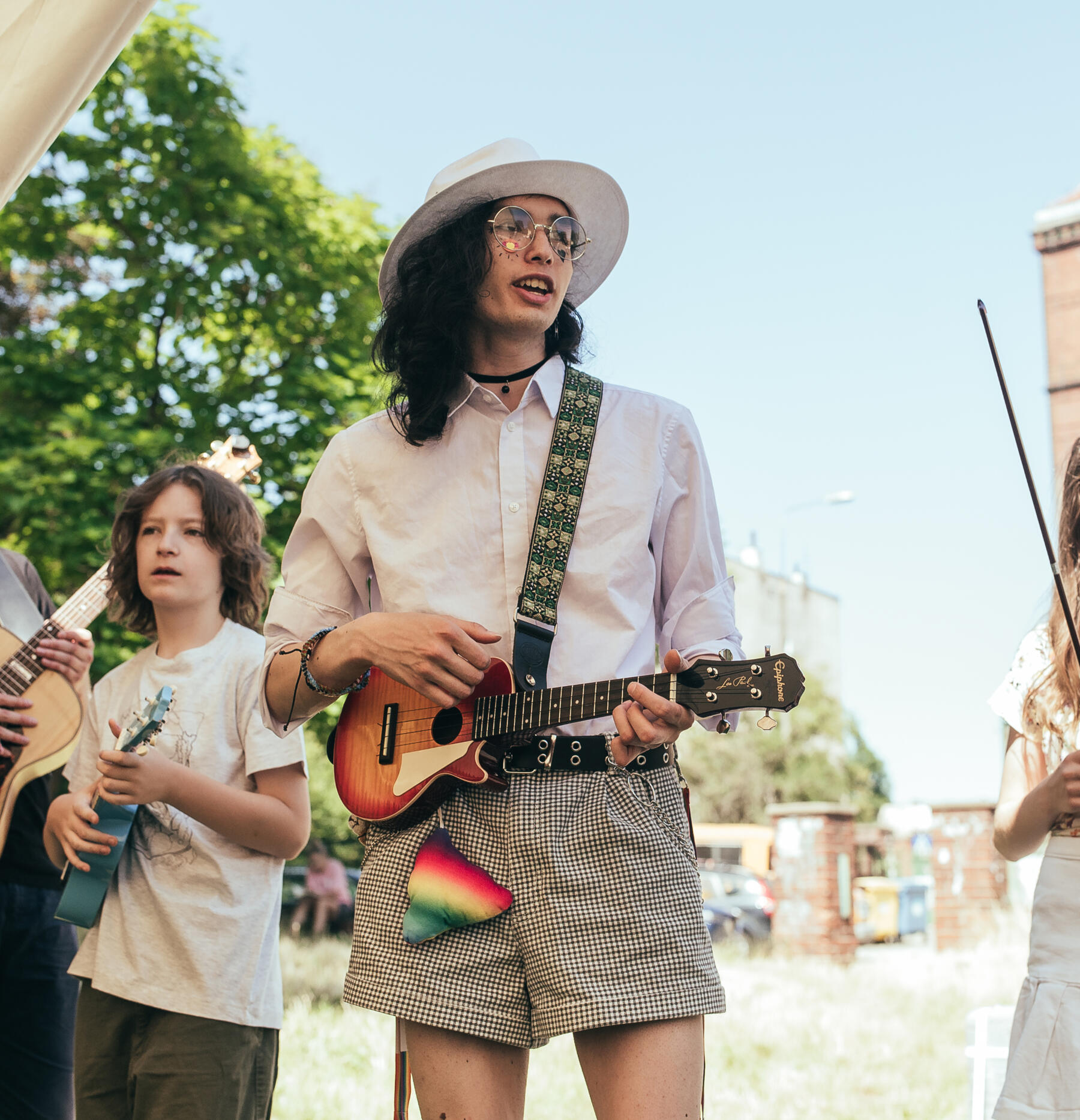 junior staff at creative summer playing the electric ukelele for an audience